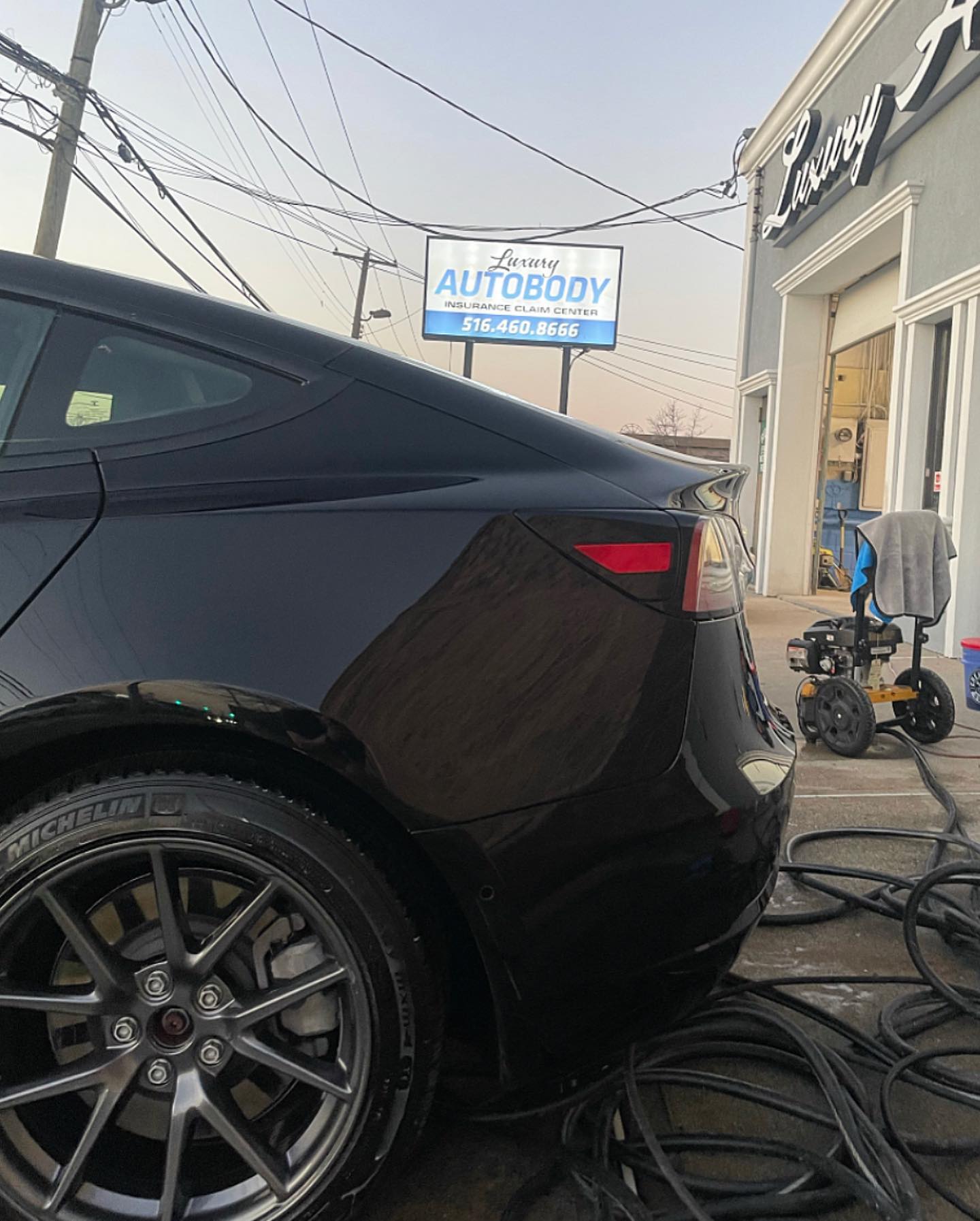 Tesla Model 3 rear quarter after repair, flawless black paint