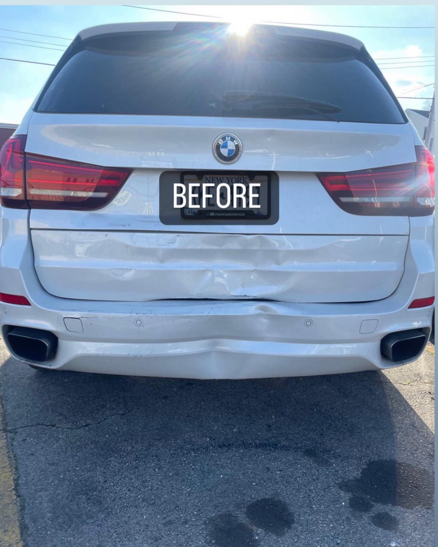 White BMW X5 rear before repair with crushed bumper and tailgate